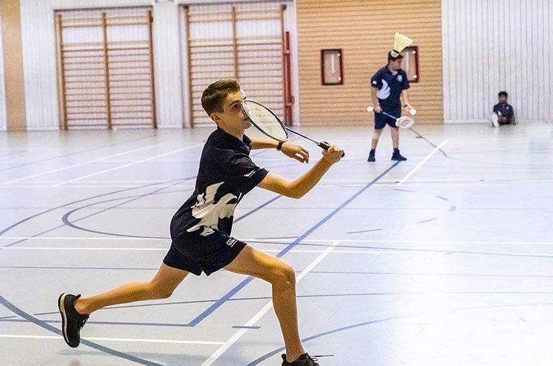 Boys Single playing at competitive badminton