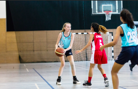 Girls playing basketball at the Sports hall