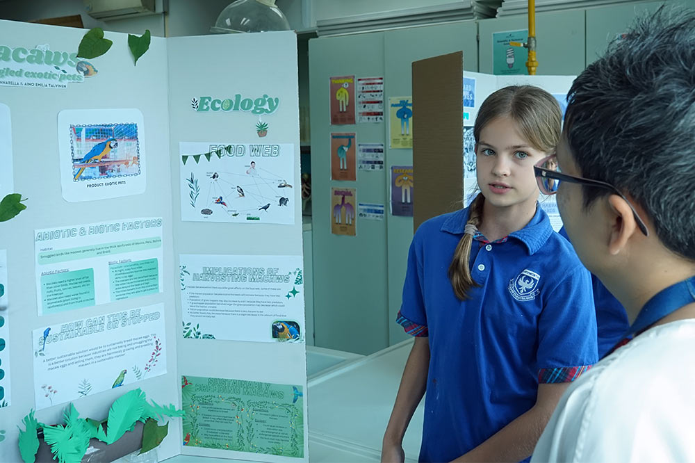 Secondary students presenting their project findings at the science fair