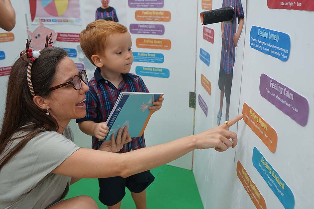 Early years student and parents viewing student work on display