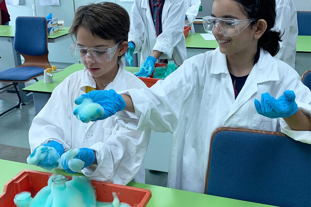 Primary students conduct the "Elephant Toothpaste" experiment in the Science Lab