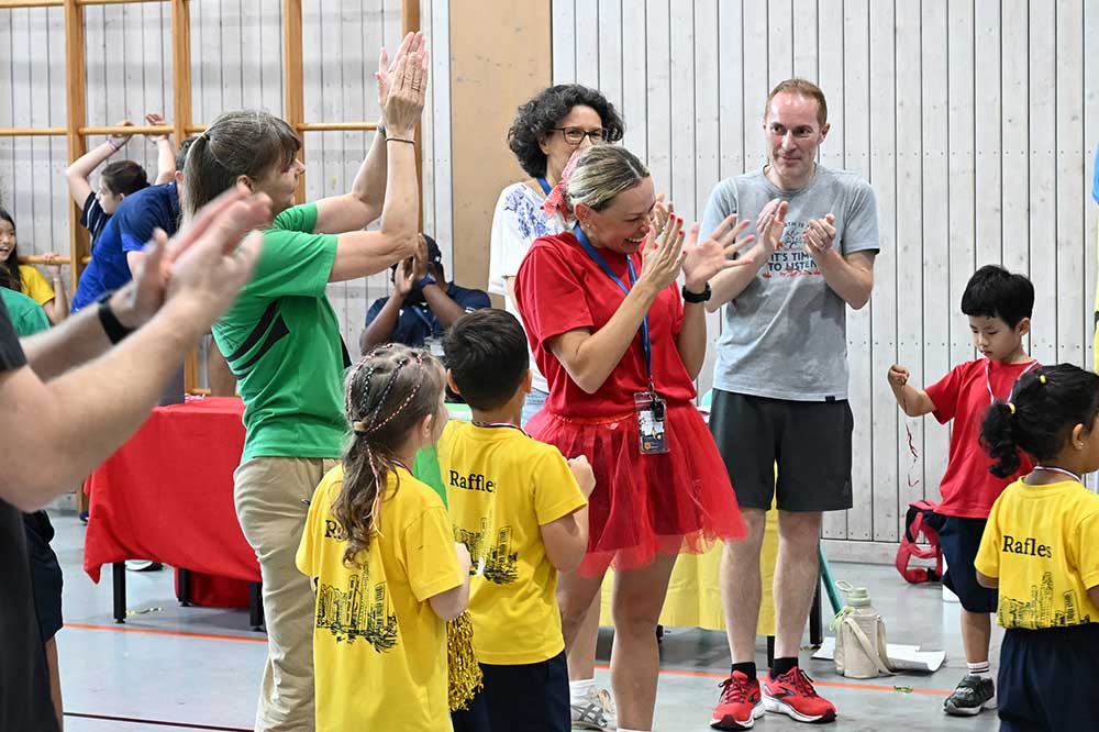 Teachers and parents cheering our kindergarteners on their Sports Day